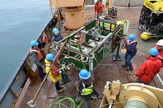 Researchers check over instrument platform after its recovery off the coast of British Columbia (Image Courtesy of Ocean Networks Canada)